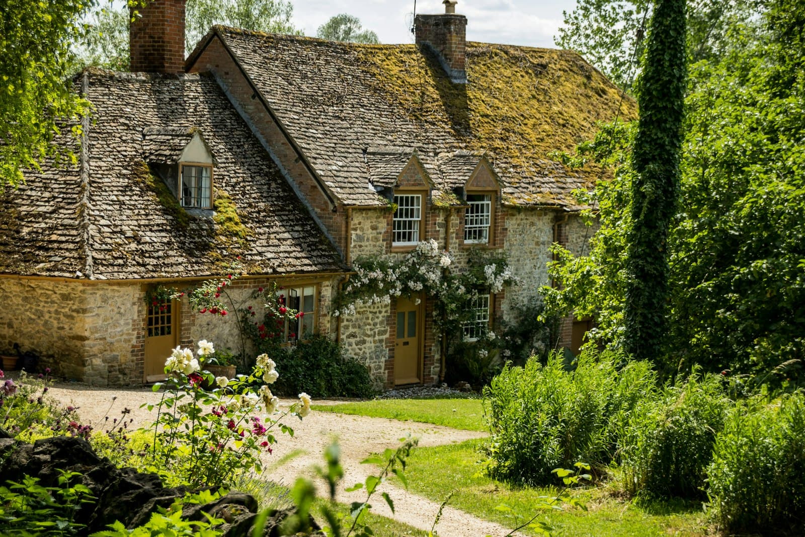 A stone country house surrounded by greenery