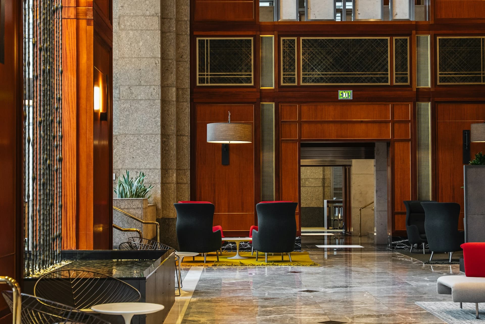 An elegant hotel lobby with modern seating and wood panelling